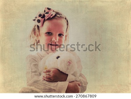 Art photo. Portrait of beautiful little girl in vintage style. The image is tinted, blurring and selective focus.