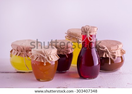 Preserved homemade fruits and berries jam in the jar. Rustic style. Selective focus.