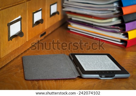 Ebook Reader in Library Stock Photo