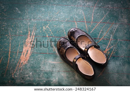 Pair of Girl Shoes on Old School Board
