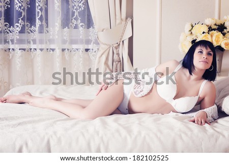 sexy woman in lingerie on the white bed