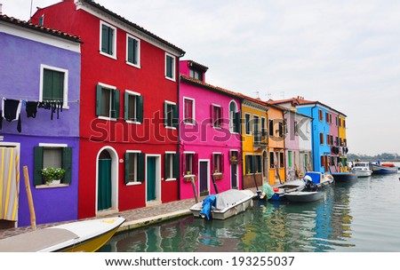 VENICE - November 8, 2013: Canal  landmark, Burano. Island canal, colorful houses church and boats, Italy on November 8, 2013 in Burano.