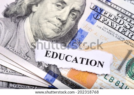 Education loan concept with dollar note and paper on foreground