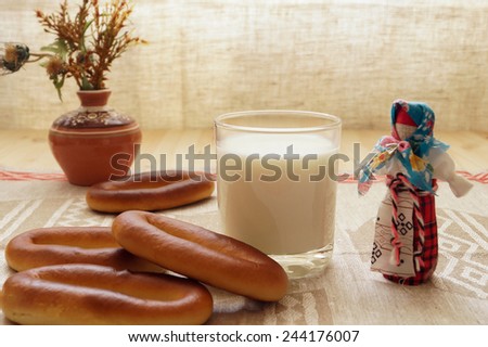 Milk and bagels. breakfast. Folk doll.