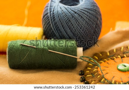 Colorful spools of thread in the foreground. Boho style. Sewing and embroidery. Embroidery thread