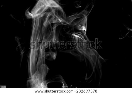Smoke swirling around against a black background