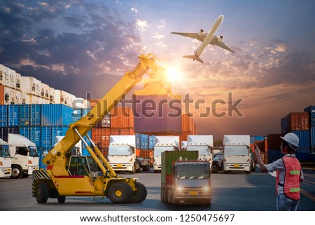 Asian female dock worker control loading Containers box to truck for Logistic Import Export Background, Business logistic concept, import and export cargo concept