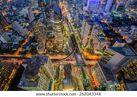 Birds eye view of Bangkok city night with a modern building at . Traffic in the business district The Skytrain station Chong Nonsi