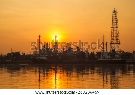 Oil and gas industry - refinery at sunrise - factory - petrochemical plantwith reflection over the river