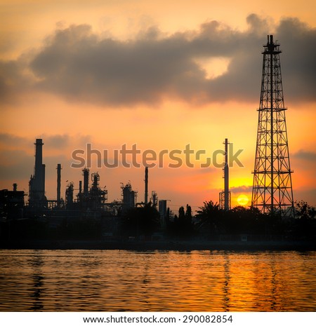 Oil and gas industry - refinery at Sunrise - factory - petrochemical plantwith reflection over the river