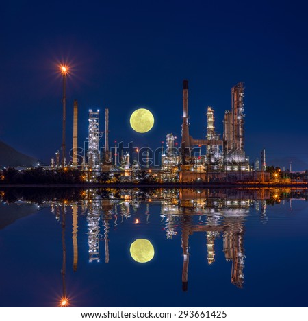 Oil and gas industry - refinery at night with reflection on water - factory - petrochemical plant