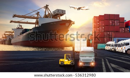 Forklift handling container box loading and Container Cargo freight ship with working crane bridge in shipyard at sunrise for Logistics Import Export background