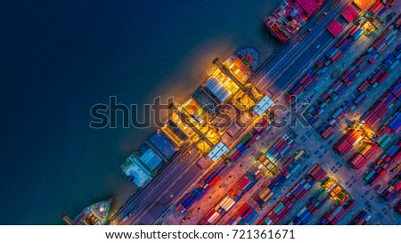Container Cargo ship and Cargo plane with working crane bridge in shipyard at sunrise