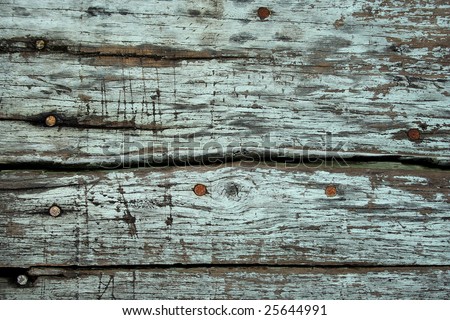 This is a textured background shot of weathered wood with some nail head.