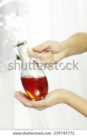 Hands of young woman holding essential oil