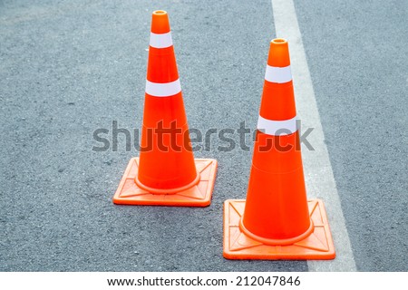 orange traffic cone placed in city street