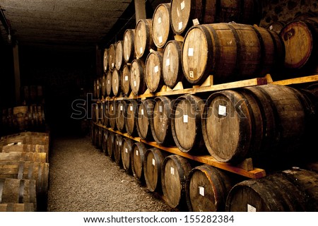 Wine Barrels Stacked In The Old Cellar Of The Winery.