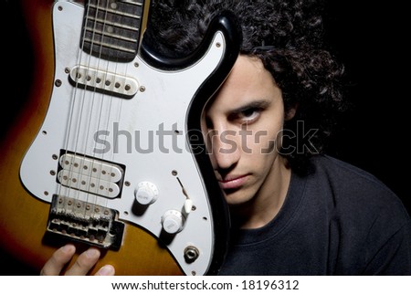 A young man face and a guitar