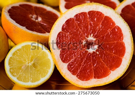 Sliced red grapefruits and lemon.