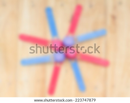 Blur colorful plastic tableware on wooden background