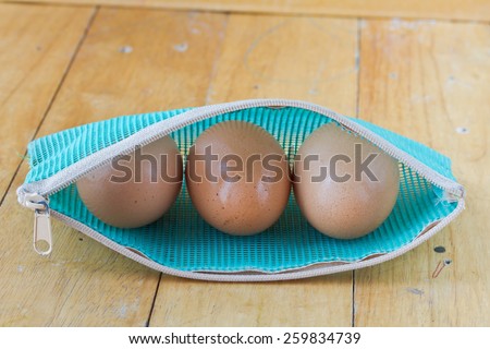 Eggs in a zipper bag on wooden table