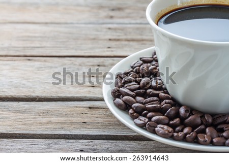 raw coffee and cup of hot espresso coffee and  on wood board