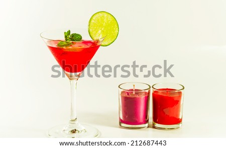 Red exotic cocktails and fruit show on table and White background