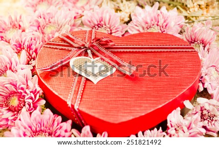 Red Heart Gift Box and flowers on Vintage retro background.(for Valentine day.)