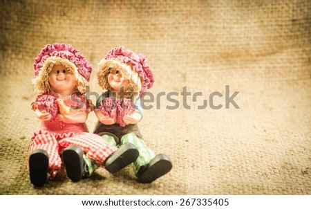 Two Lovely doll sitting  in a vintage retro style backgrounds for the day of love,
