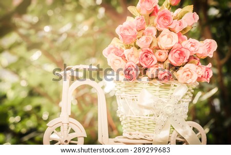 Roses in the basket bicycle on vintage style soft focus for background.