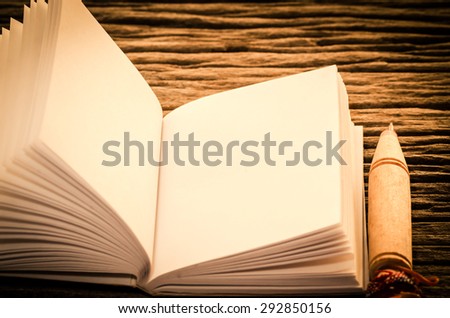 Vintage,retro of note book paper and pen on wooden background soft focus.