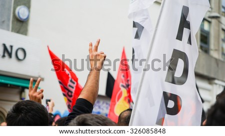ISTANBUL - OCTOBER 10   Protesters hold up peace signs and carry flags at a peace demonstration in Istanbul, Turkey following a suicide bombing that earlier killed dozens in the Turkish capital Ankara