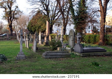Crowded church yard, with gravestones  in the evening sun, St. Margaret\'s Church, Blackheath, UK