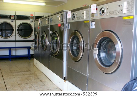 Row of old and broken washing machines at the laundromat