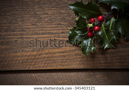 Photo of Holly leafs on old wooen table