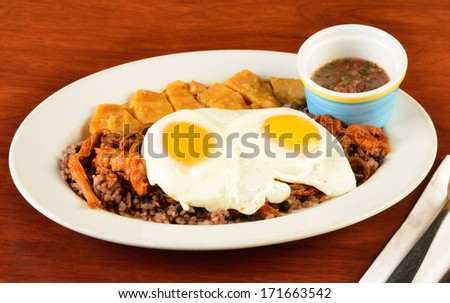 Fried eggs on rice and beans.