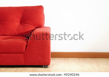 Red sofa on wooden floor.