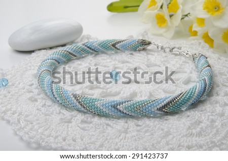 Handmade beaded necklace on a white background.