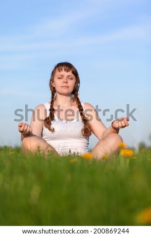 The girl meditates in nature