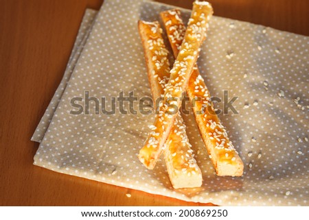 Bread sticks  with cheese and sesame on  the napkin