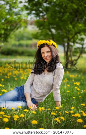 pretty woman on dandelions field, happy cheerful girl resting on dandelions meadow, relaxation outdoor in springtime,