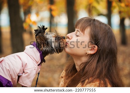 Closeup portrait of the smiling girl of the disabled person and her dog, look at each other