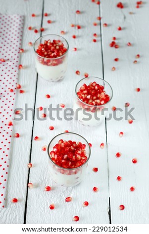 Healthy gluten free panna cotta dessert with  pomegranate seeds in jars perfect for breakfast or christmas holidays