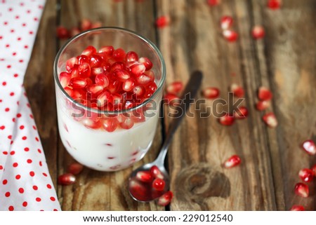 Jelly gelatin cream dessert or panna cotta with pomegranate seeds in glass