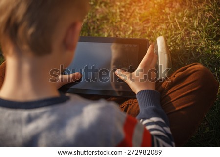 Close-up of kid\'s hands close up holding  digital tablet for playing and education
