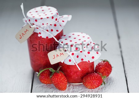 Fresh strawberry homemade jam in jar and strawberries on white background. healthy organic and vegan food.