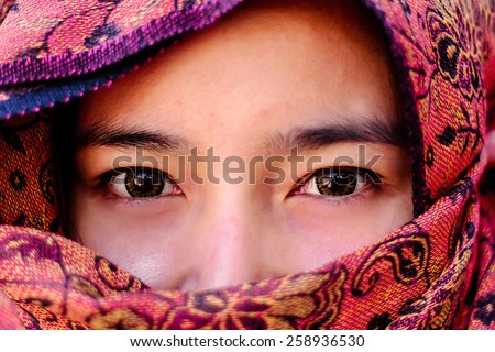 woman makeup on eyes hidden her face with shawl