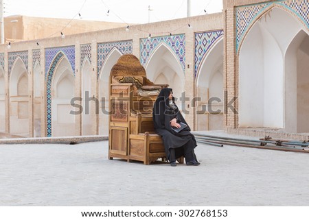 KASHAN, IRAN - MAY 1, 2015: Woman in Agha Bozorg Mosque in Kashan, Iran. The mosque was built in the late 18th century by master-mimar Ustad Haj Sa\'ban-ali, is located in the center of Kashan.