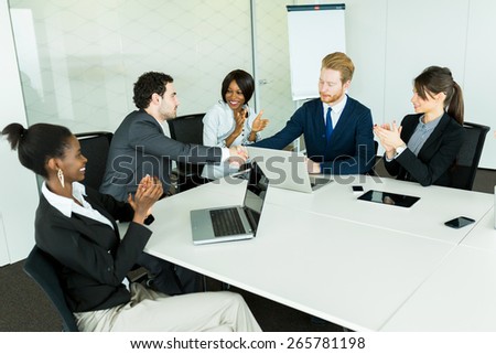 Business deal made between two businessmen in a neat office environment followed by a round of applause