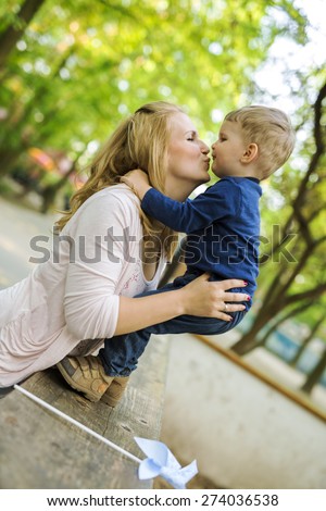 Parent touching noses with her son and smiling happily